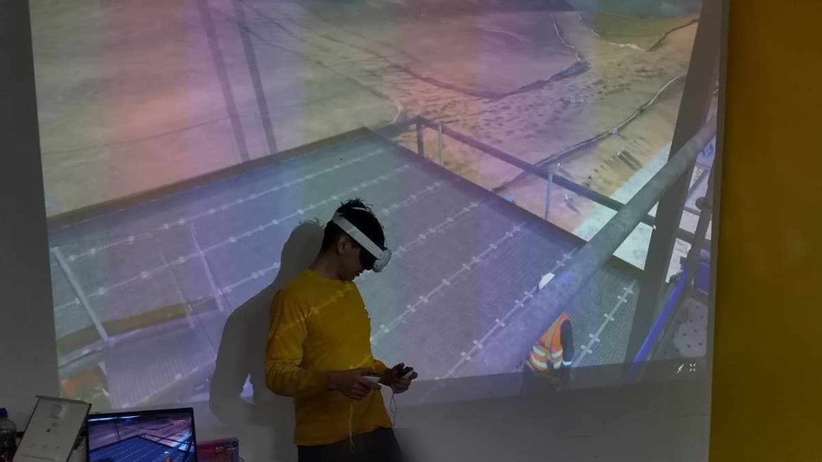 Participante usando lentes de realidad virtual para simular una maniobra en altura